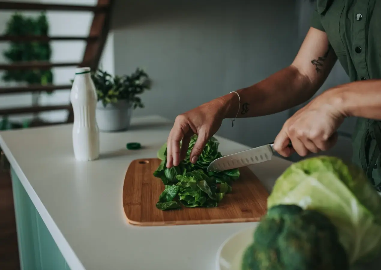 Chopping greens on a wooden board